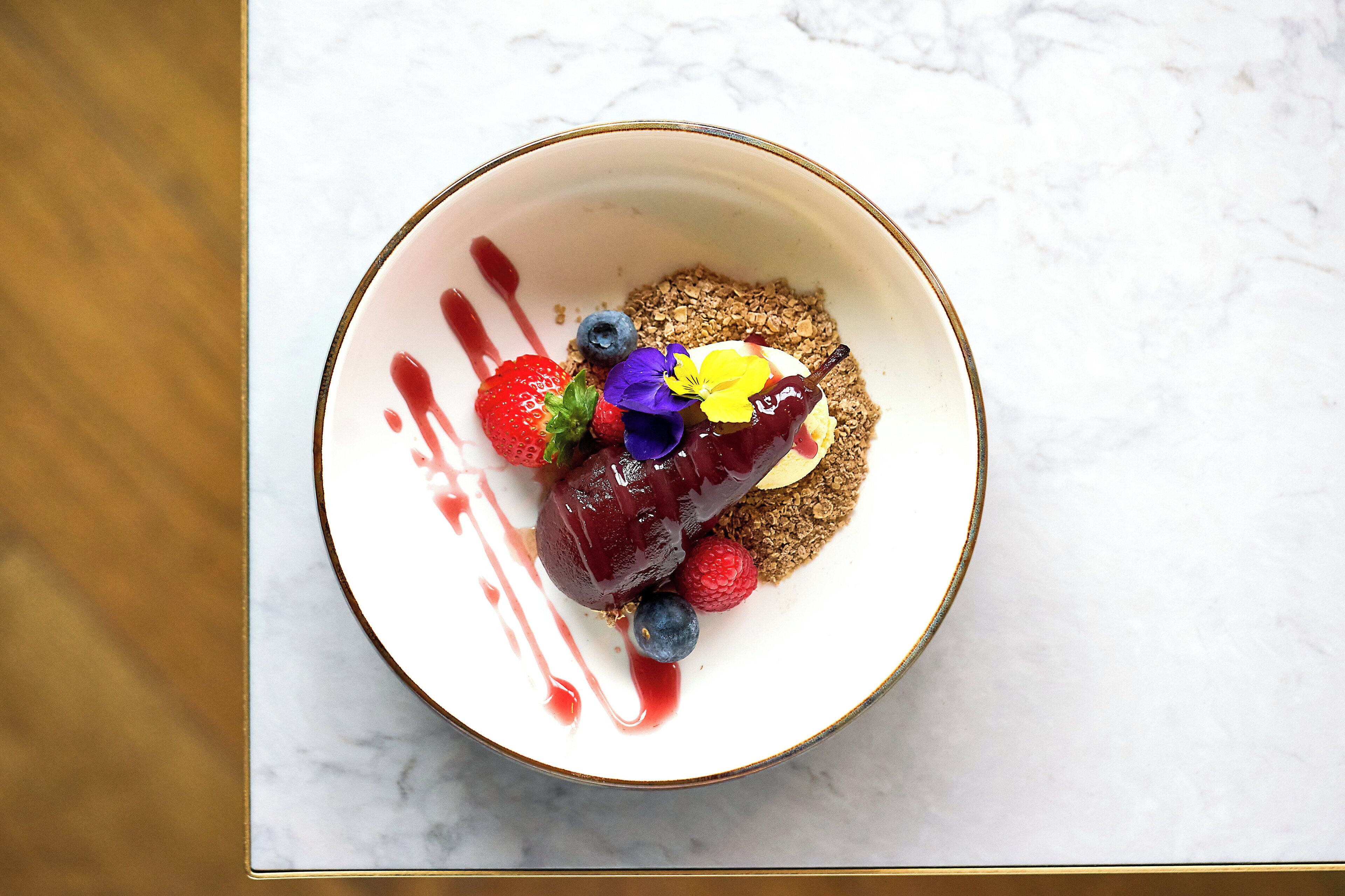 A dessert with berries and a chocolate glaze on a plate.