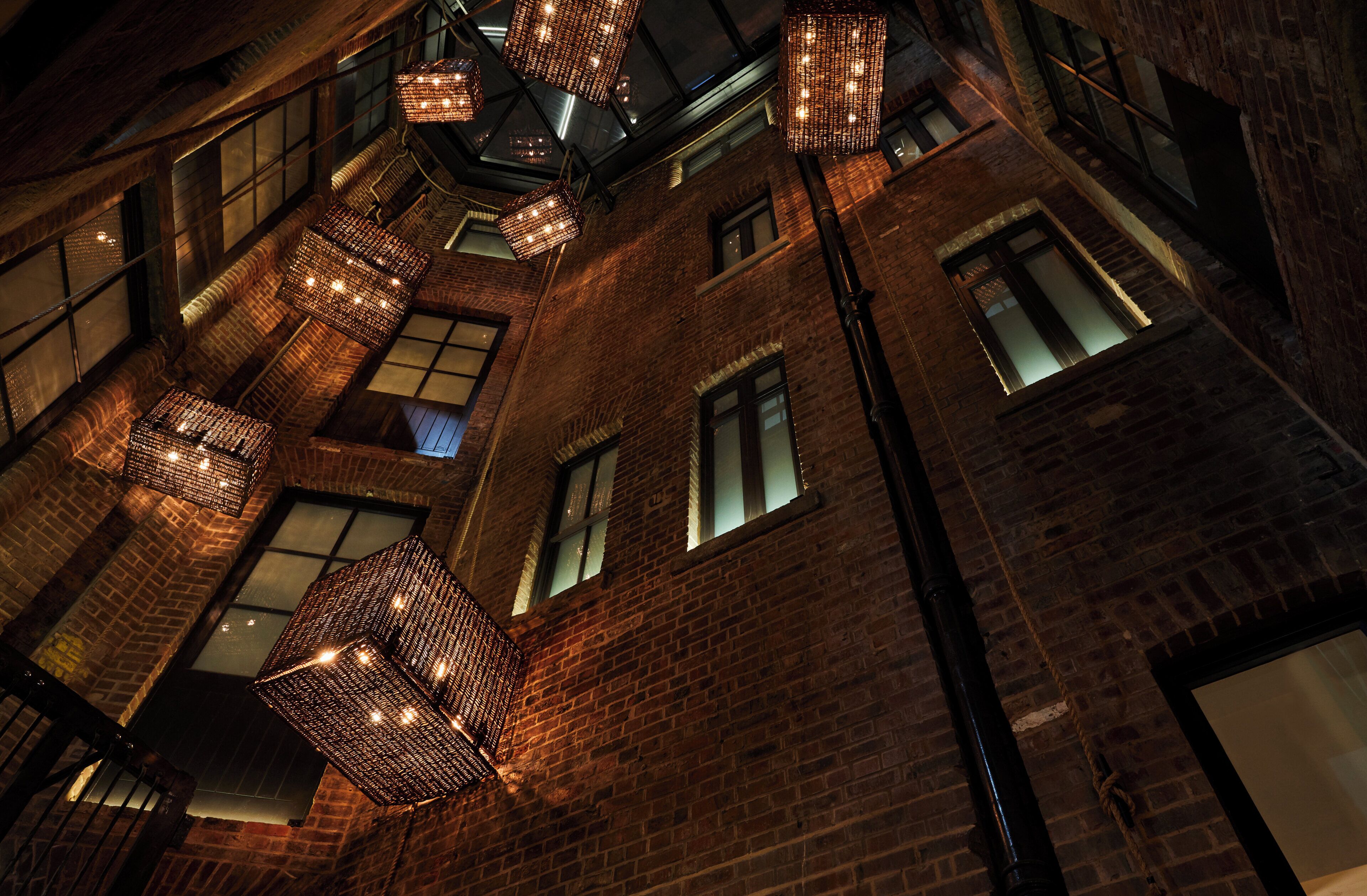 A multi-story building with exposed brickwork and multiple windows.