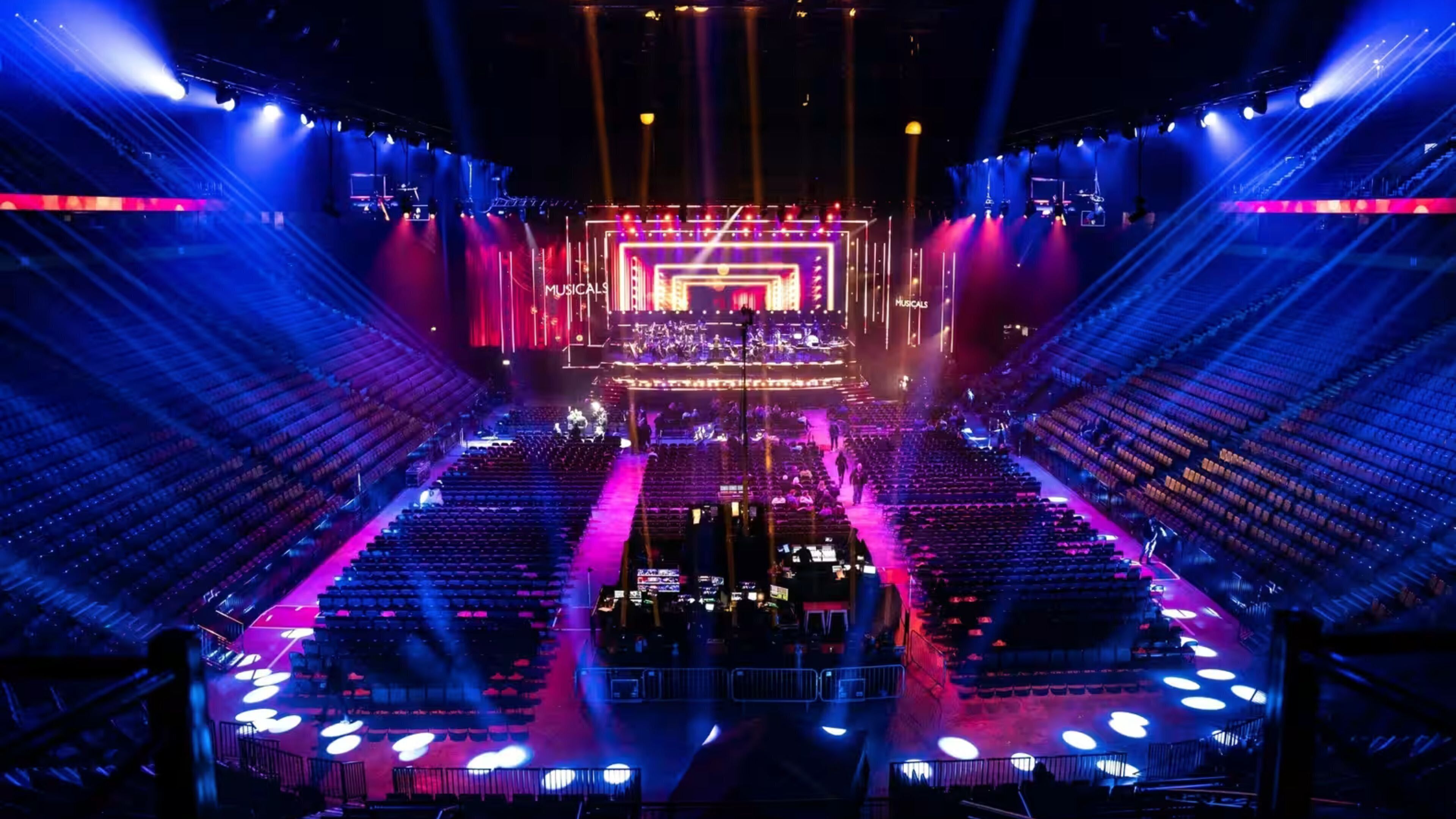A large auditorium with tiered seating and a stage at the front.