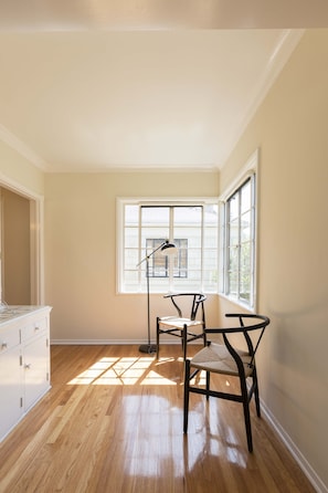 Enjoy the high ceiling and expansive view from the large window with multiple panes.