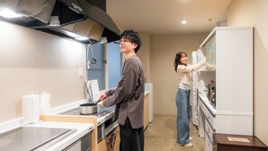 A kitchen with a stove, sink, and refrigerator. - GRAND HOSTEL LDK ODORI PARK (Sapporo)