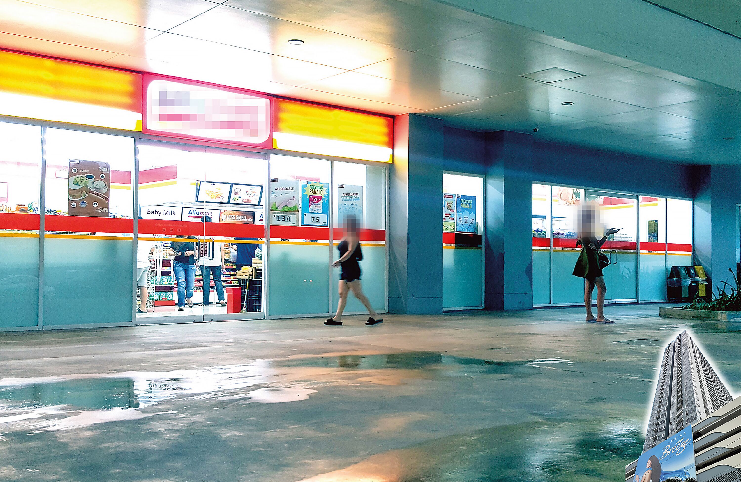 A spacious indoor area with a large window, a vending machine, and a signboard.