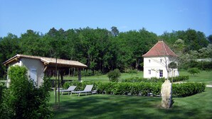 A white building with a red roof, surrounded by lush greenery and a well-maintained lawn. - La Tour charming cottage near St Emilion (Lugaignac)