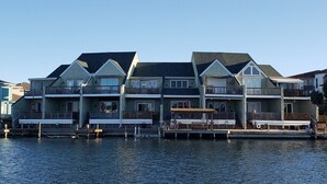 A row of waterfront houses with balconies and dock access. - REEL Paradise! <br>*Perfect Couple's Retreat or Big Fun For A Small Family* (Corpus Christi)
