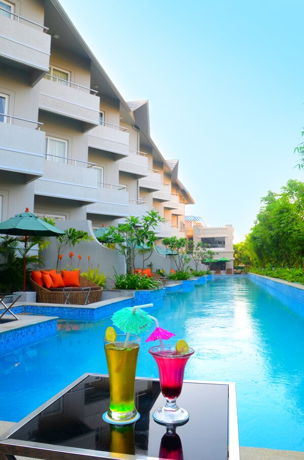 Outdoor pool, open 7 AM to 7 PM, pool umbrellas