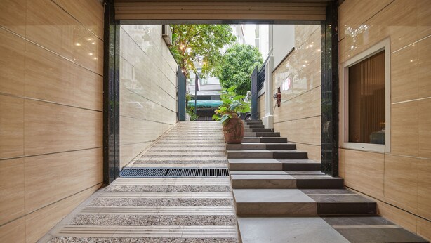 A modern staircase with alternating steps and a potted plant at the top. - Bin Bin Hotel 2 - Near Him Lam D7 (Ho Chi Minh City)