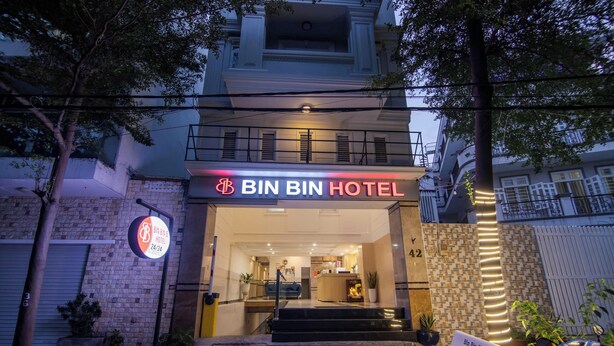 The BIN BIN HOTEL entrance with a sign, a staircase, and a bench outside. - BinBin Hotel 5 - Near Lotte Mart D7 (Ho Chi Minh City)