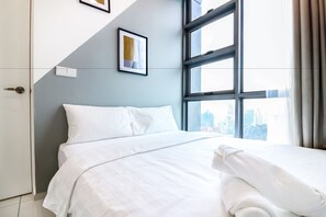 Deluxe Suite, 2 Bedrooms | Desk, laptop workspace, iron/ironing board, rollaway beds
