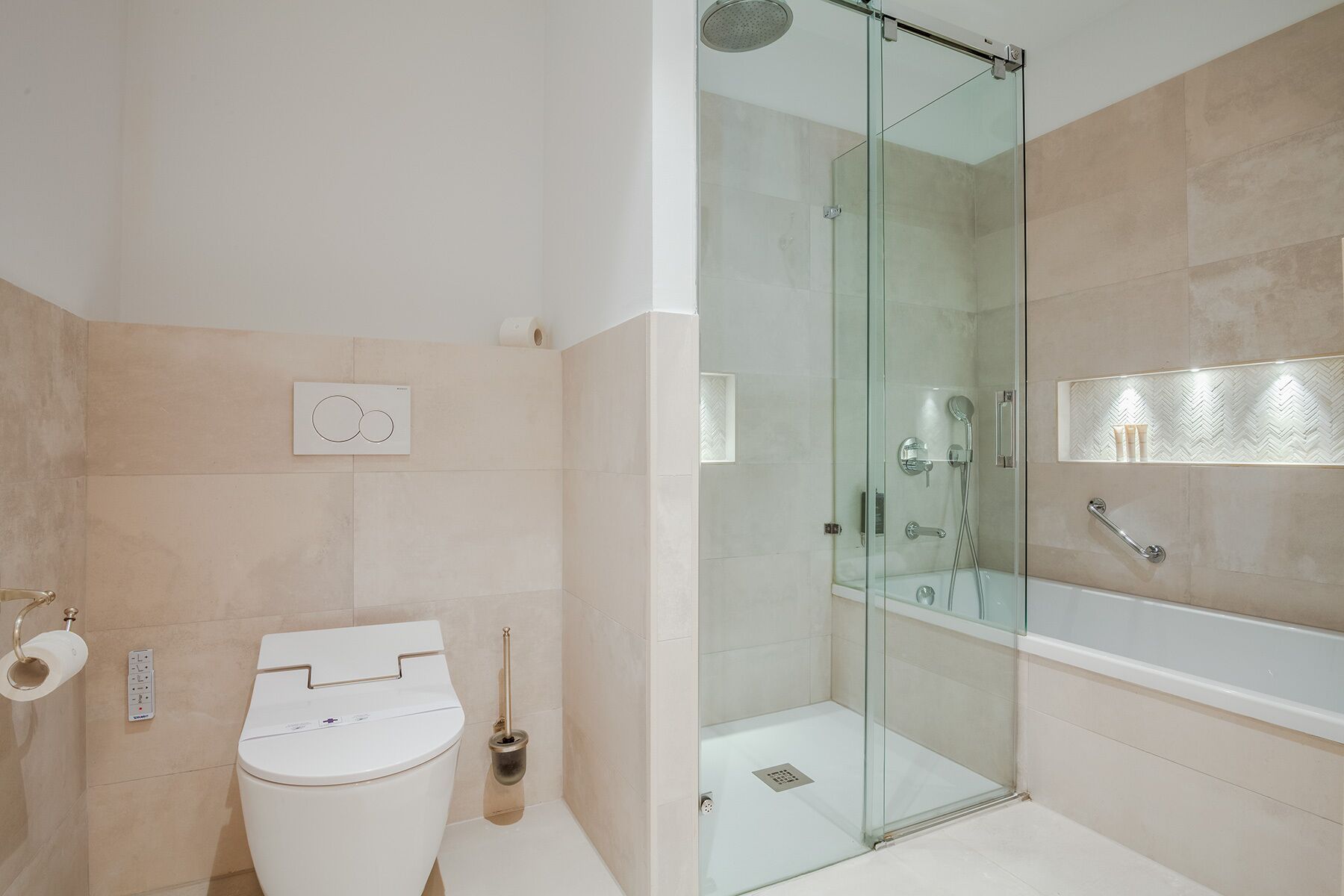 A modern bathroom with a glass-enclosed shower, a white toilet, and a bathtub.