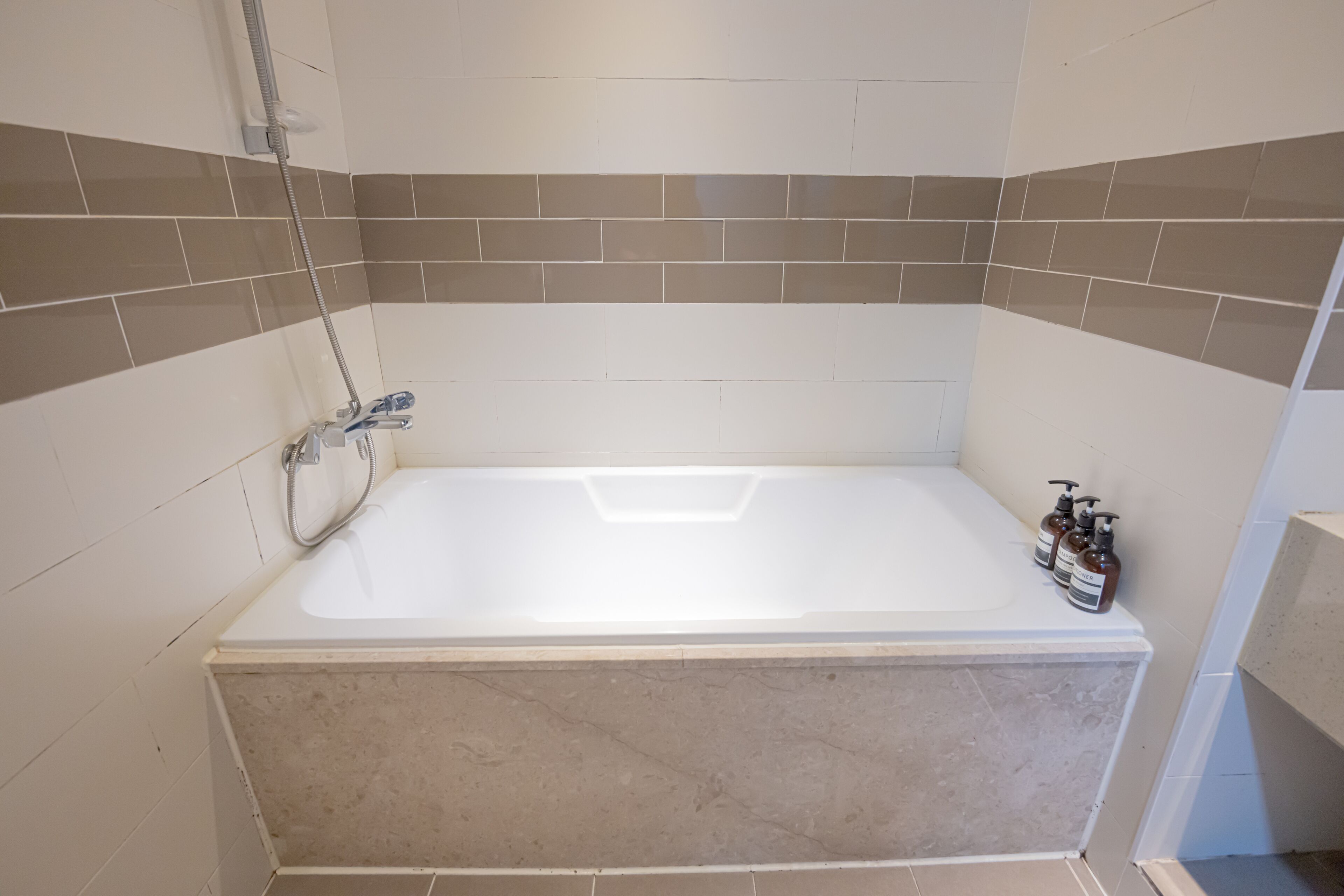 deluxe double room | bathroom | separate bathtub and shower, deep-soaking bathtub, designer toiletries