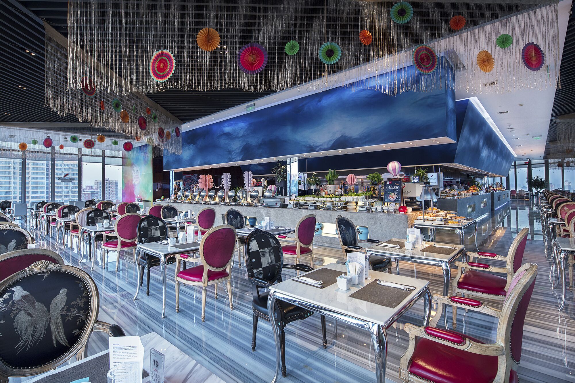 A spacious restaurant with high ceilings, modern decor, and a variety of seating options.