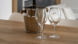 A wooden table with a champagne bucket and two wine glasses. - Ca' de la Fonte | WENICE Deep Culture (Venice)