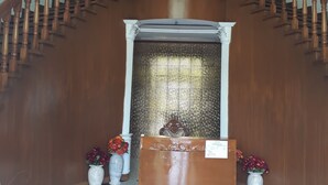 A grand staircase with a wooden handrail and a chandelier. - Andres Resort (Nabas)