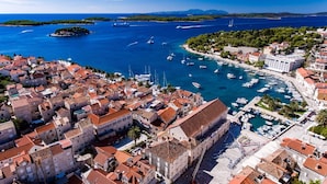 A coastal town with historic buildings, a marina, and clear blue waters. - Hotel Teranea (Hvar)