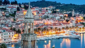 A coastal town with historic architecture, a prominent clock tower, and a marina with boats. - Hotel Teranea (Hvar)