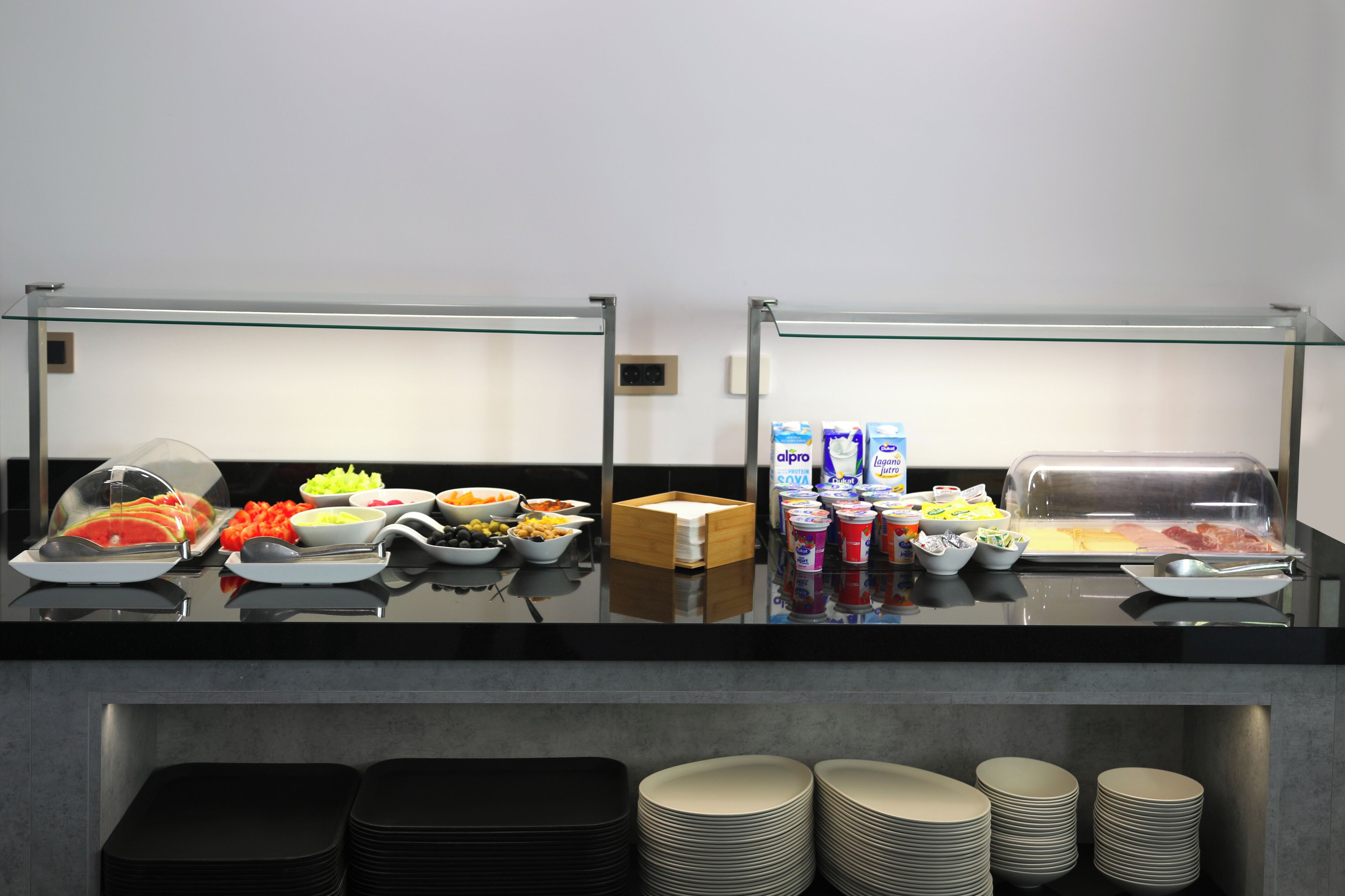 A buffet setup with various food items and condiments.