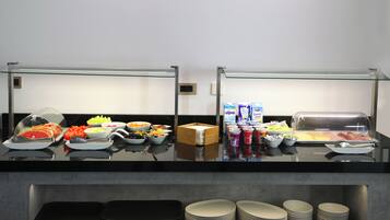 A buffet setup with various food items and condiments.