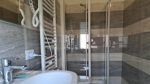 A modern bathroom with a large sink, toilet, and shower area. - Park Hotel (Camaiore)