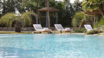 Seasonal outdoor pool, open 9:00 AM to 7:00 PM, pool umbrellas
