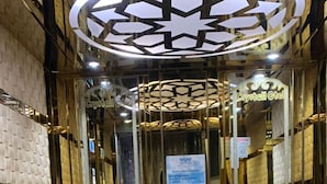 An elevator with a patterned floor and a circular ceiling design. - Crystall Hotel (Van)