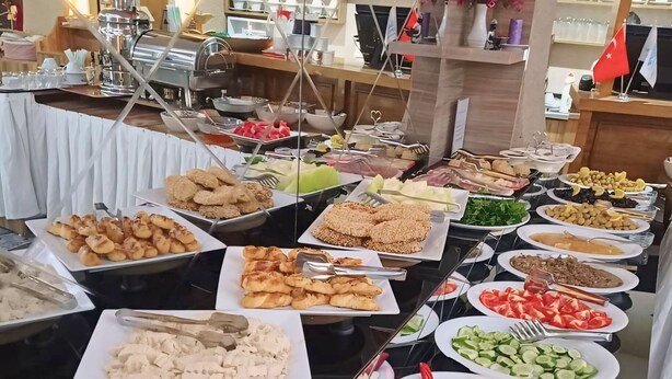 A buffet with various food items including salads, meats, and desserts. - Crystall Hotel (Van)