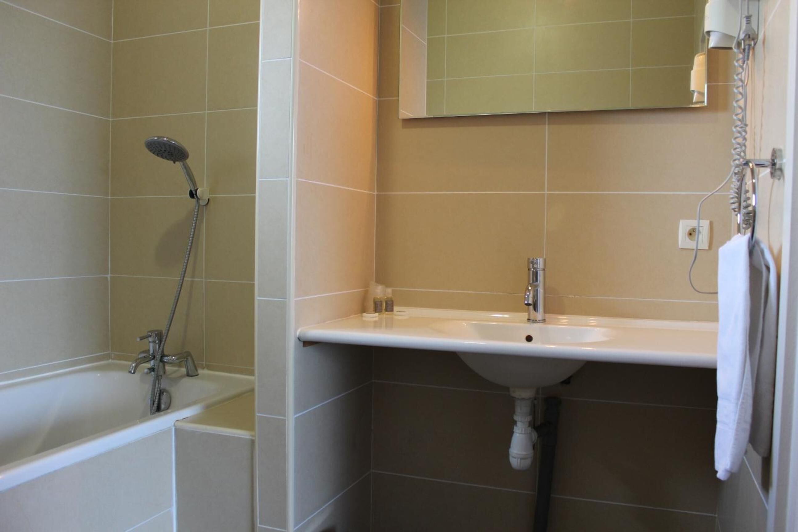 A bathroom with a bathtub, a shower, and a sink.