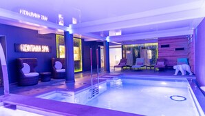 A modern spa area with a pool, seating, and a sign reading "MONTANA SPA". - Montana Chalet Hôtel Spa (Enchastrayes)