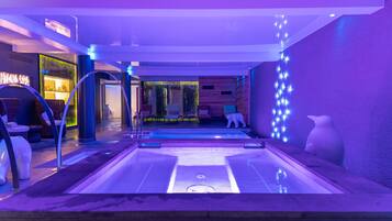 Relax by the serene pool surrounded by lounge chairs and a seating area with a view.