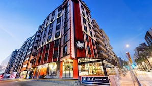 A multi-story hotel with a prominent 'CAY' sign, large windows, and a 'GASTROPUB' sign indicating a dining area. - HAY Hotel Alsancak (Izmir)