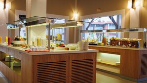 A buffet setup with multiple glass display cases and a wooden counter.