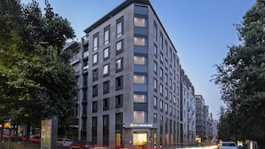 A modern multi-story hotel with a prominent entrance and a visible sign indicating it is a hotel. - Dorma Liberdade (Lisbon)