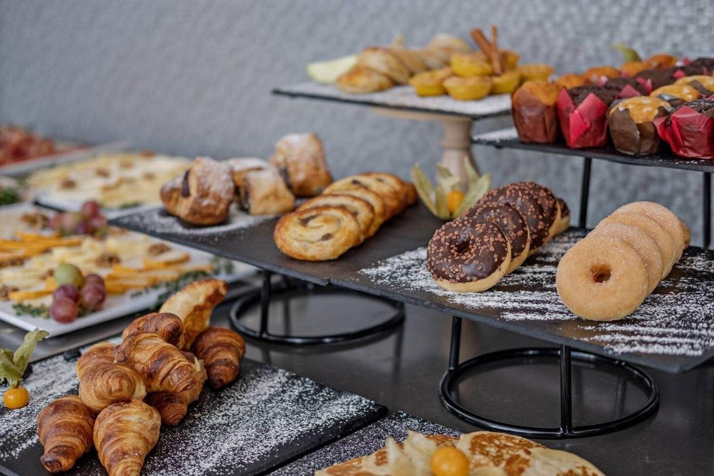 A variety of pastries and desserts displayed on a multi-tiered serving stand.