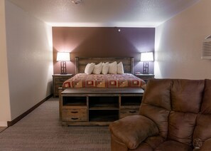 Suite ejecutiva, 1 cama King size | Área de sala de estar | Televisión de pantalla plana 