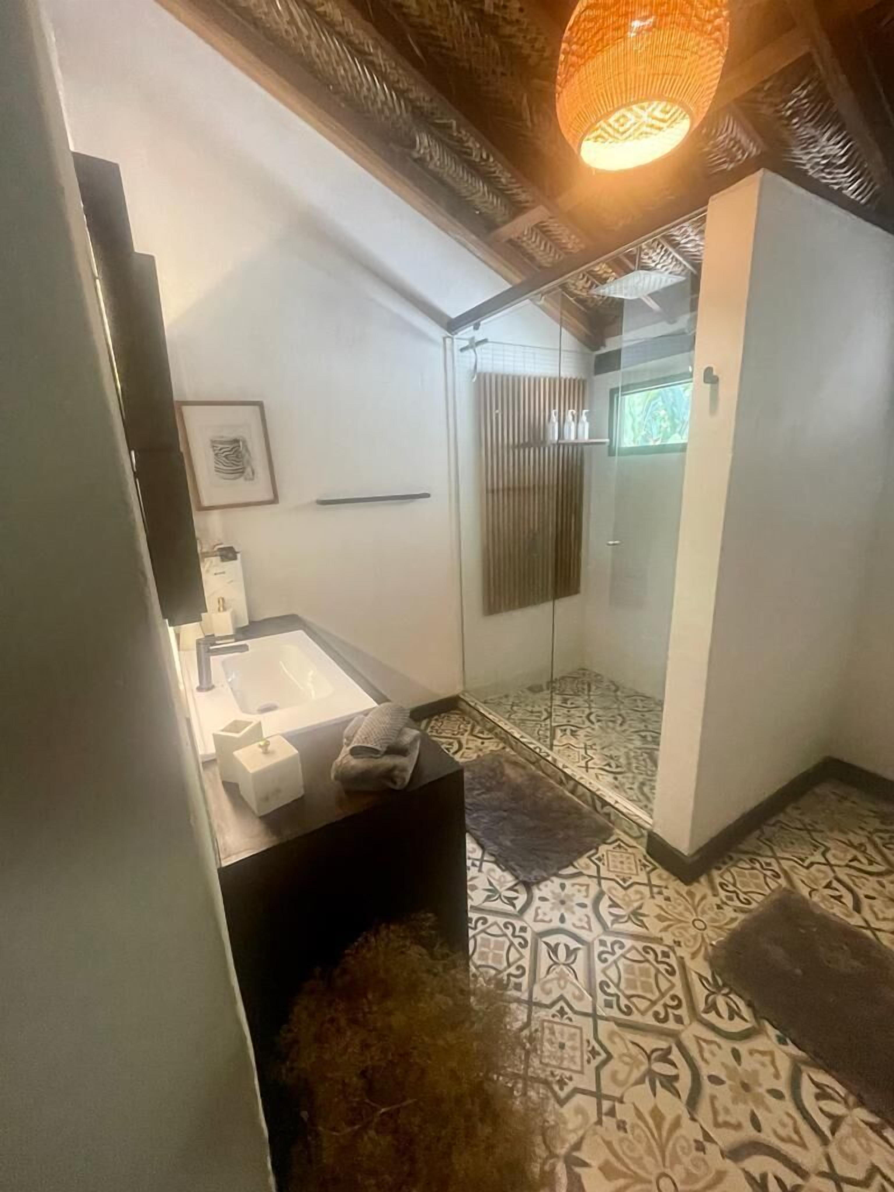 deluxe suite | bathroom | shower, rainfall showerhead, designer toiletries, towels