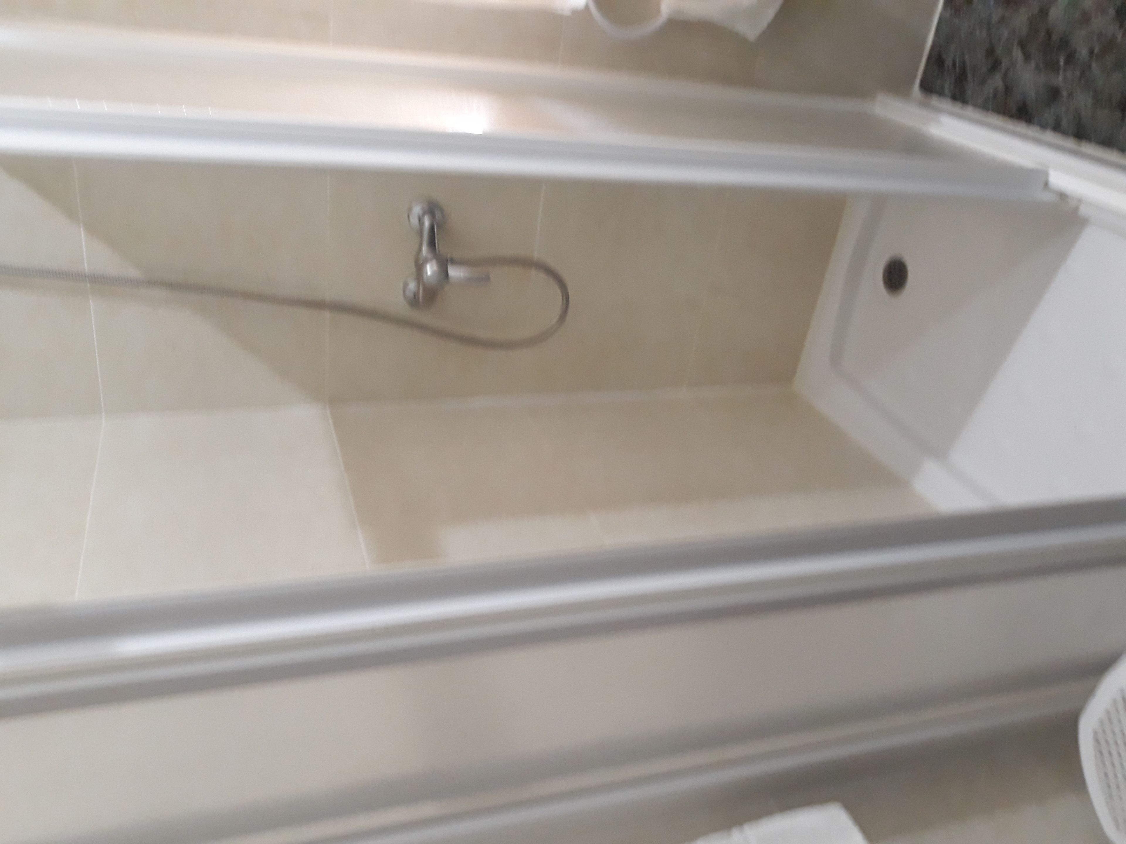 A clear view of a bathroom with a bathtub, a shower area, and a toilet.