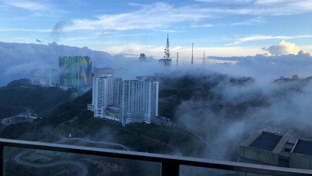 A high-rise building with multiple floors, surrounded by clouds and mist, indicating a foggy or misty weather condition. - Sky D'Mont Suites (Genting Highlands)