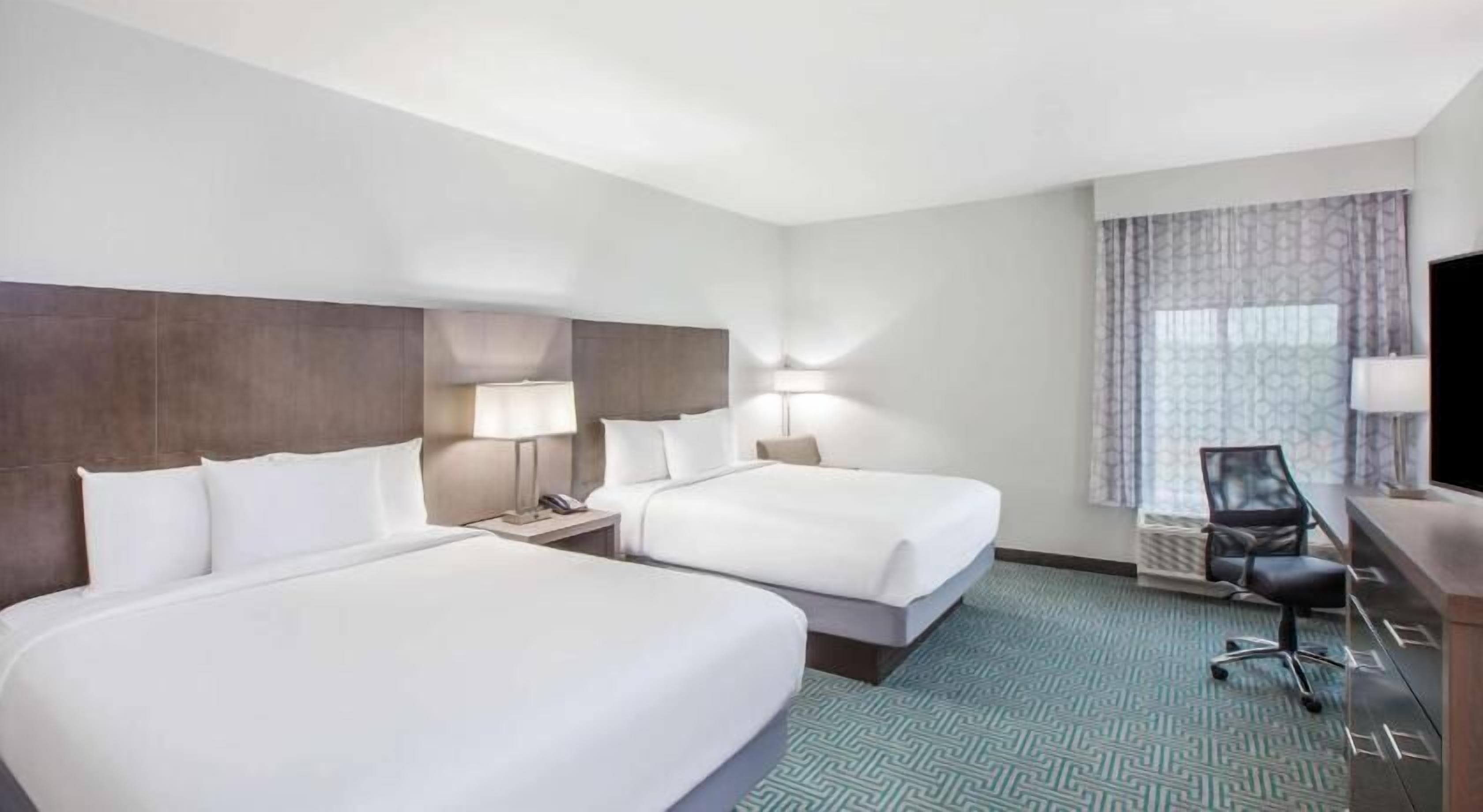 Premium bedding, desk, laptop workspace, soundproofing