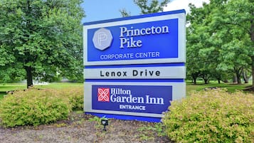 A Princeton Pike Corporate Center sign with Lenox Drive and Hilton Garden Inn entrance.