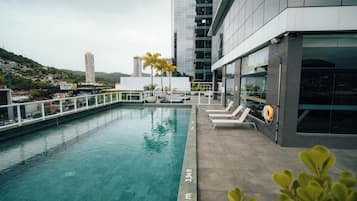 Outdoor pool, open 10:00 AM to 10:00 PM, pool loungers