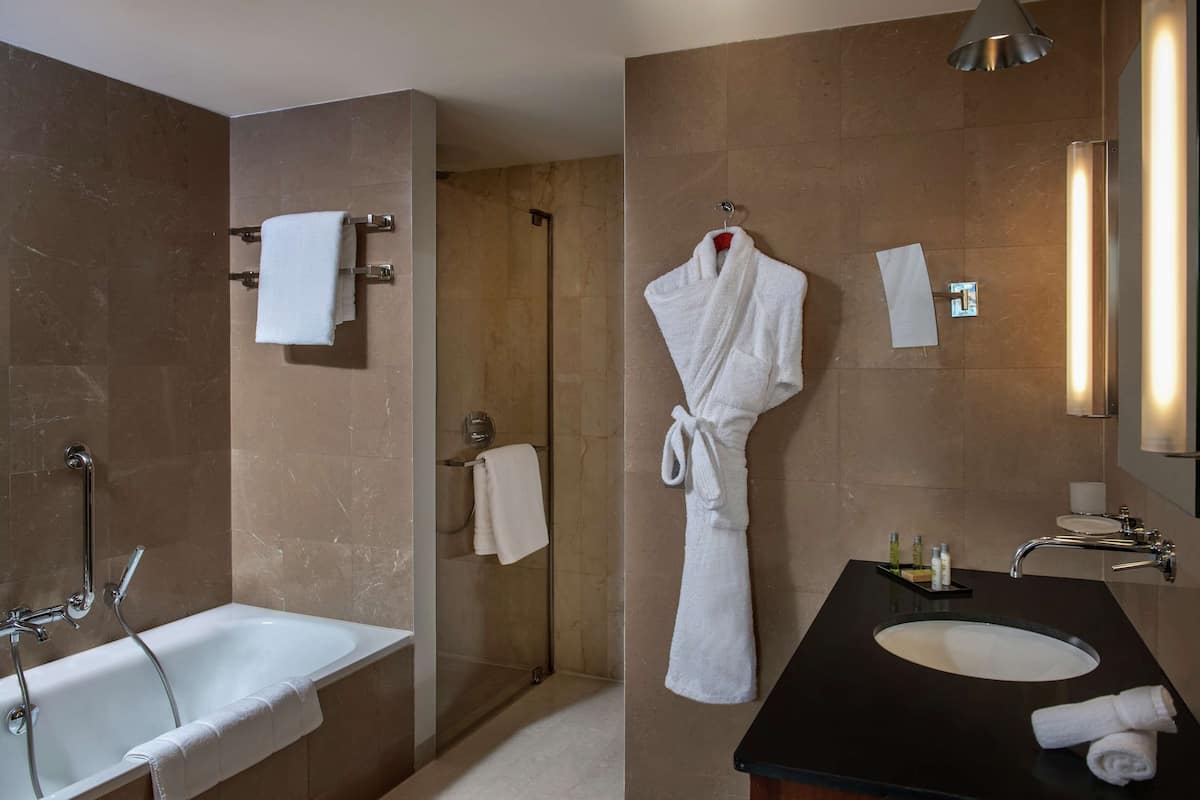 executive room, 1 king bed | bathroom | rainfall showerhead, designer toiletries, hair dryer, bathrobes