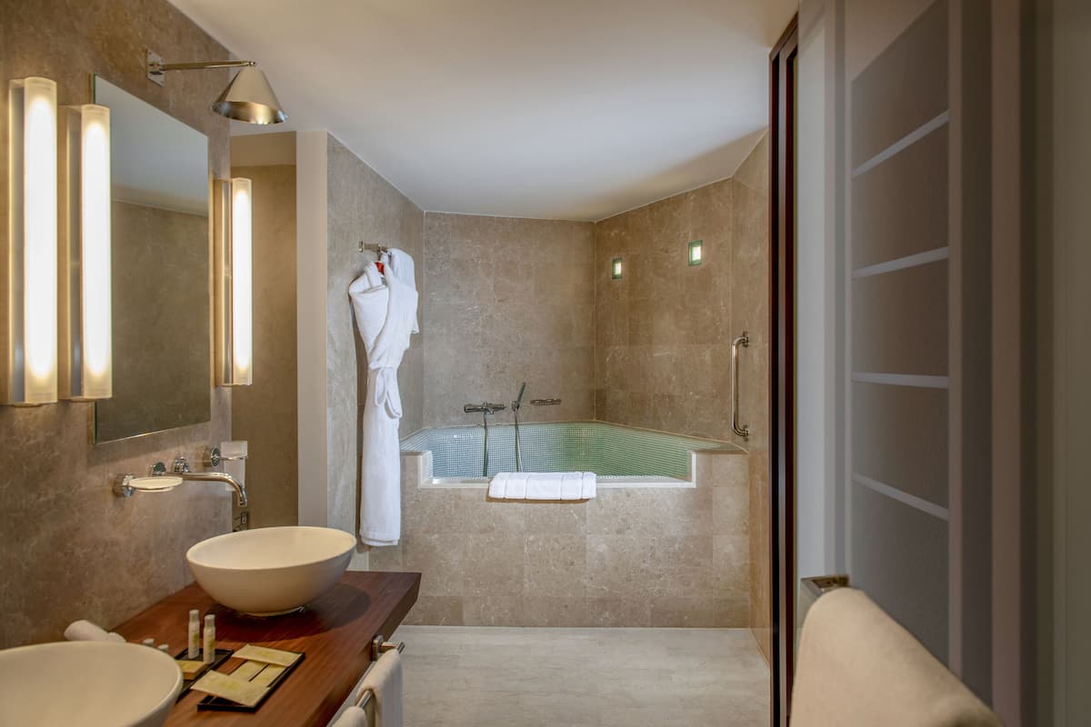 rainfall showerhead, designer toiletries, hair dryer, bathrobes