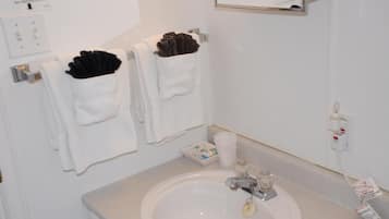 A bathroom with a sink, towel rack, and a mirror.
