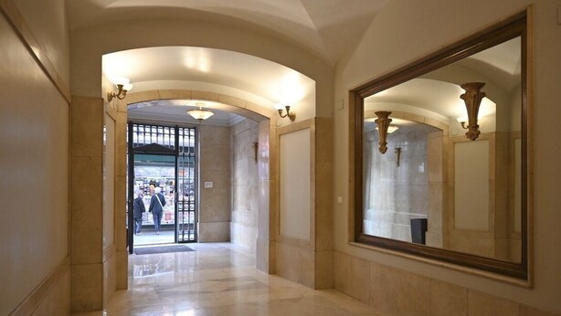 A hallway with a large mirror, arched ceiling, and a door leading to a public area. - 4 bedrooms appartmts (València)