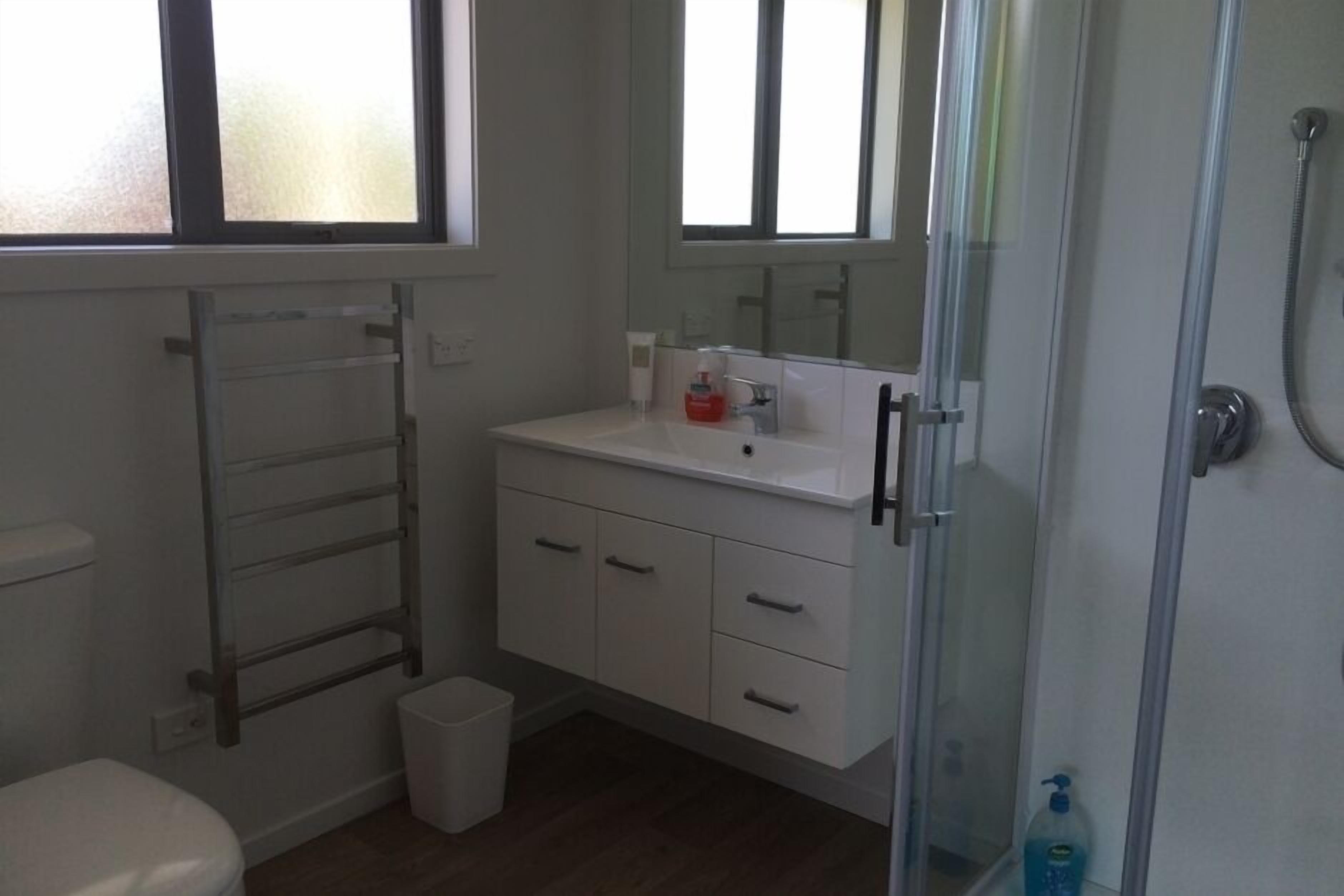 Bathtub, hair dryer, towels, toilet paper