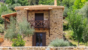 A stone building with a balcony, surrounded by greenery. - Mystras Village House (Sparta)