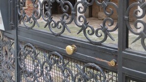A wrought iron gate with intricate designs, leading to a courtyard with arches and columns. - A magnificent XVth Century gothic Noble Palace on two canals. (Venezia)