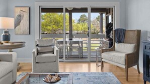 A living room with a sofa, armchair, coffee table, and a painting on the wall. - Cozy 3BR / 3.5 BA Retreat - Neighborhood Pool!  access included! (Johns Island)
