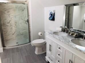 A bathroom with a shower, toilet, sink, and cabinet. - Spectacular Marsh Views! Walk to North Beach!  Sleeps 8! Amenity Access included! (Seabrook Island)