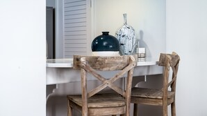 A wooden chair with a cross-back design placed at a white table. - View of Edisto & Ocean! Walk to Pools, Golf! Amenity Access included! (Seabrook Island)