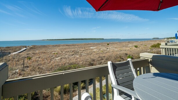 A deck with a view of a beach and ocean. - View of Edisto & Ocean! Walk to Pools, Golf! Amenity Access included! (Seabrook Island)